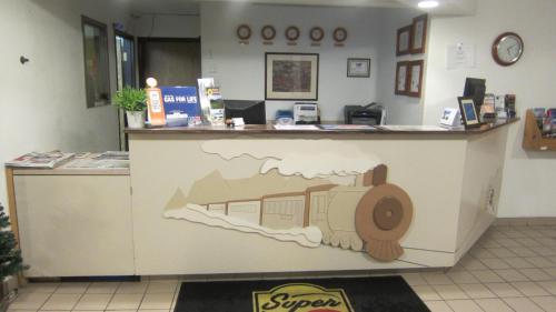 a counter in a store with a train painted on it at Super 8 by Wyndham Revelstoke BC in Revelstoke