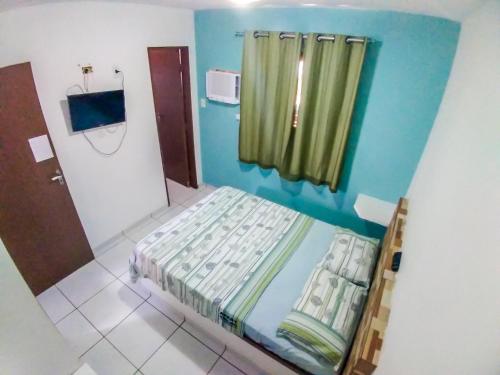 Ein Bett oder Betten in einem Zimmer der Unterkunft Apartamento Mobiliado Mozart
