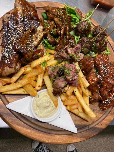 a plate of food with meat and french fries at Essex Arms in Huntly