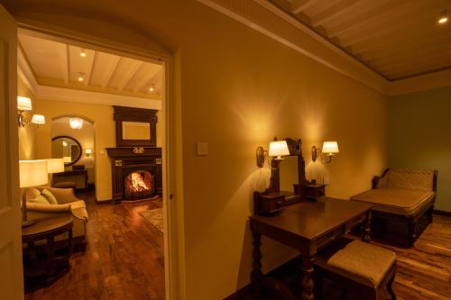 a room with a living room with a fireplace at Savoy - IHCL SeleQtions in Ooty