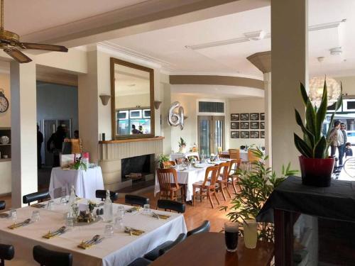 a restaurant with tables and chairs and a mirror at Essex Arms in Huntly