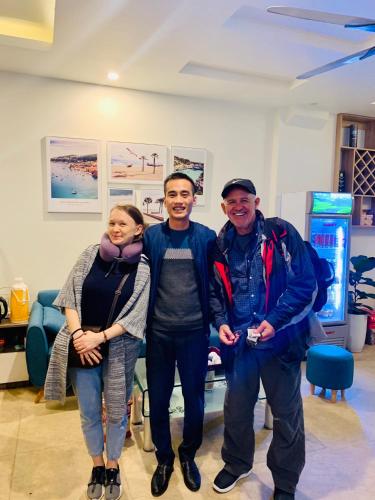 a group of three people posing for a picture at New Sky Airport Hotel in Noi Bai