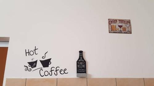 a bottle of hot coffee and a bottle of wine on a wall at Domus Quarticelli Costa dei Trabocchi in Torino di Sangro