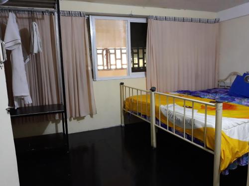 a bedroom with a bunk bed and a window at Vanny's Peaceful Guesthouse in Phnom Penh