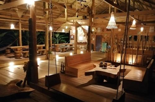 a large room with a couch and a table in it at FANDEE ISLAND Treehouses & Ziplines - Tad Lo, Bolaven Loop Pakse in Ban Kiangtat