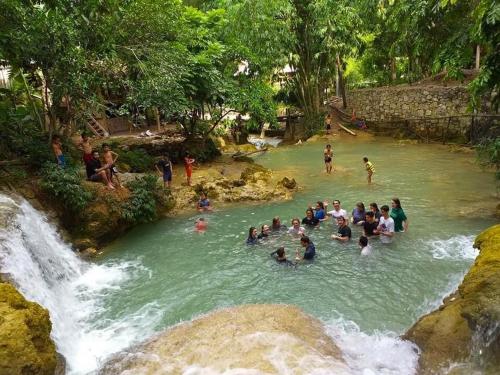 a group of people swimming in a river at LePont Mu Waterfall Bungalow in Hòa Bình