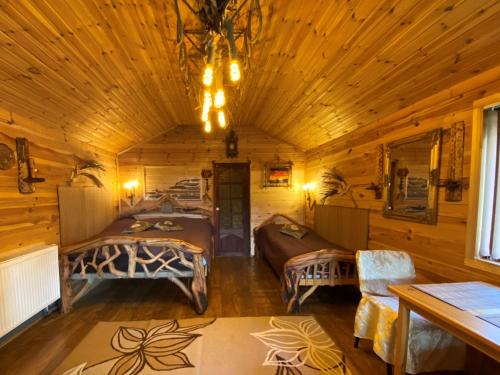 a room with two beds in a wooden cabin at Guest House Melon in Jūrmala