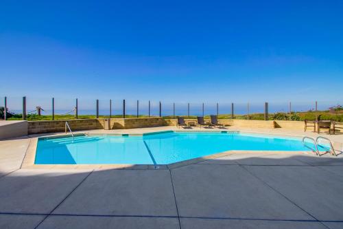 a swimming pool with a view of the ocean at Work Friendly Oceanfront SURF25 Condo in Solana Beach