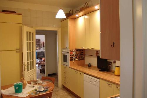 a kitchen with yellow cabinets and a table in it at MAREBLU Rapallo Mare in Rapallo