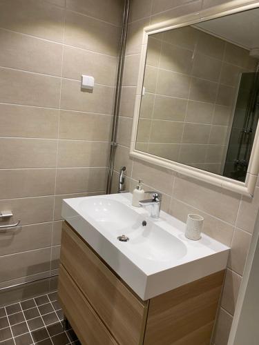 a bathroom with a white sink and a mirror at Apartment in Turku center in Turku