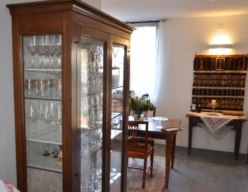 a dining room with a wine cabinet and a table at Antica Sosta dei Viandanti in Cadenazzo