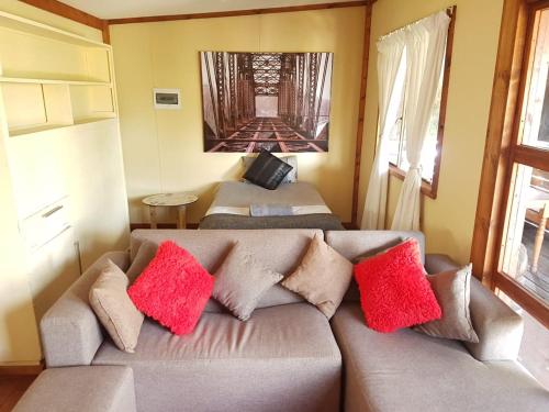 a living room with a couch with colorful pillows at Havana Nights in Graskop