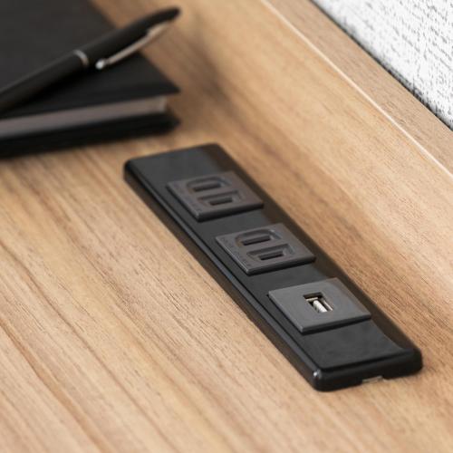 a black remote control sitting on a wooden table at ART HOTEL Aomori in Aomori