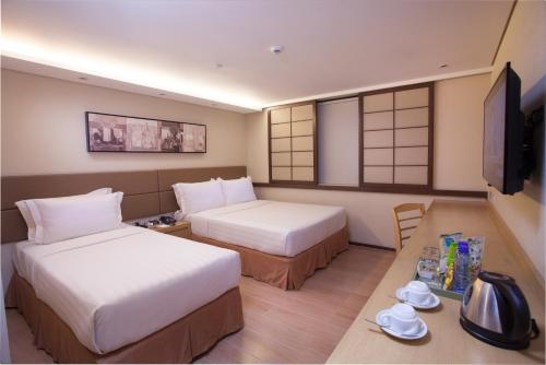 En eller flere senger på et rom på Jinjiang Inn - Makati