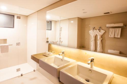 a bathroom with a sink and a mirror at Jinjiang Inn - Makati in Manila