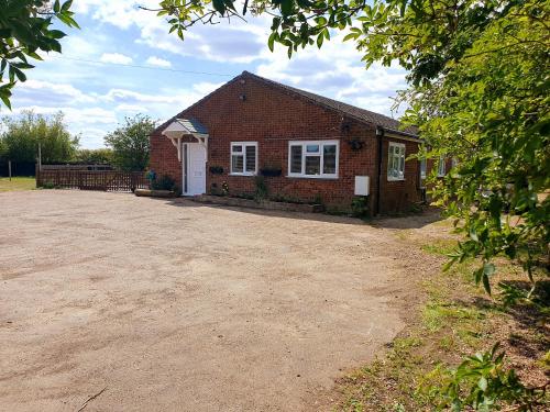 a brick house with a driveway in front of it at Sherwood Bungalow 3 Bedroom Entire Property in Boston