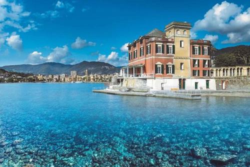 a large building in the middle of a large body of water at MAREBLU Rapallo Mare in Rapallo