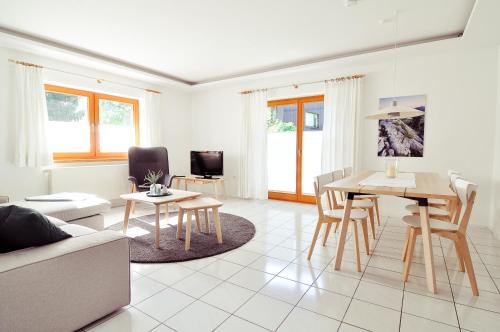 a living room with a couch and a table at Ferienwohnungen Evi Huber in Oberammergau