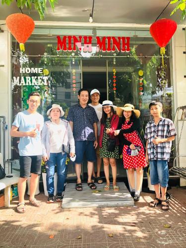 a group of people standing in front of a store at Minh Minh Homestay in Con Dao