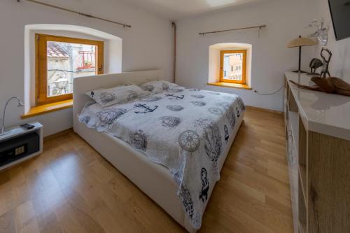 a bedroom with a bed and a kitchen with windows at Krka Waterfalls in Skradin