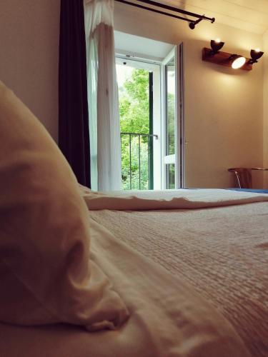 a bedroom with a bed and a door with a window at Casello68 in Levanto