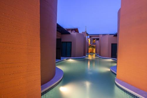 a swimming pool in the middle of a building at Rachabhura Hotel in Ratchaburi