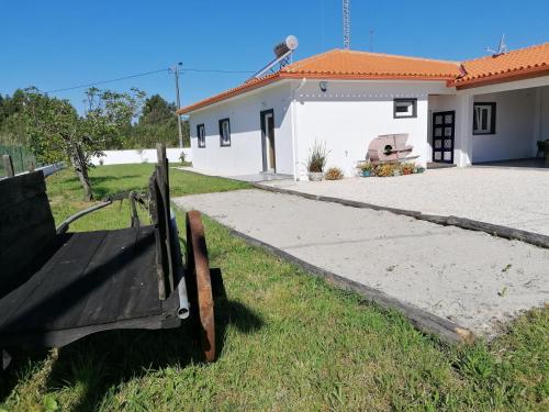 a house with a bench in front of it at Casa Moderna Proxima da Praia in Santa Catarina