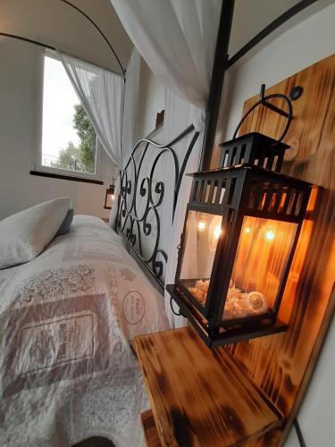 a bedroom with a bed with a wooden head board at ca del pescatore in Cervo