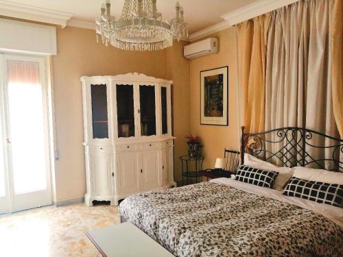 a bedroom with a bed and a chandelier at Residenza Carlo di Borbone in Caserta