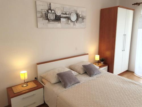 a bedroom with a bed with two pillows on it at Apartments Huljić in Hvar