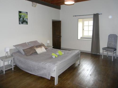 a bedroom with a bed with two tennis balls on it at Manoir de Herclat in Néville-sur-Mer