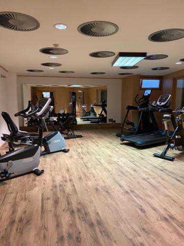 a gym with several treadmills and exercise bikes at Hotel Tyrolis in Zirl
