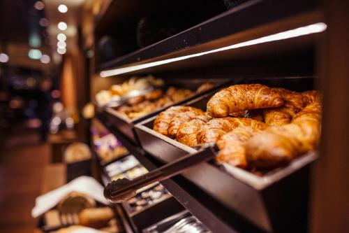 a row of trays of croissants and other baked goods at Delta Hotel in Vlaardingen