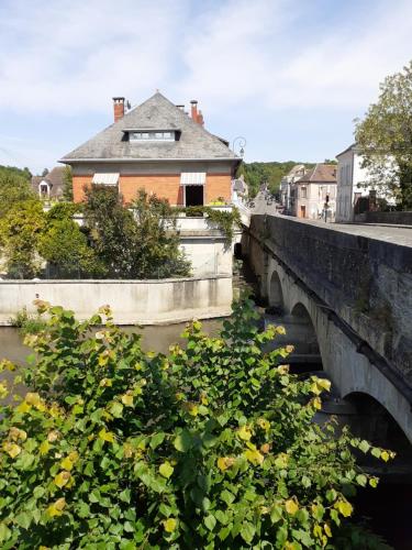 a house sitting on a bridge over a river at Chambres d'hôtes GOBILLON in Maintenon