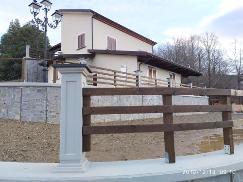 a wooden fence in front of a house at I fiori del Pollino - Guest House in San Severino Lucano