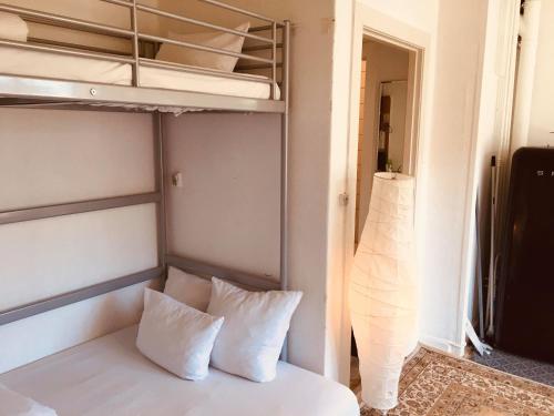 a bedroom with a bunk bed with white pillows at Nice room in apartment in Amager in Copenhagen