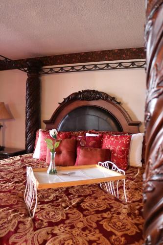 a bedroom with a bed with a wooden headboard at Dakota Inn in Huron