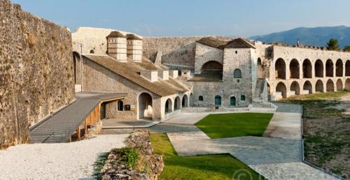 an old building with a wall and a courtyard at In The Castle - House in Ioannina