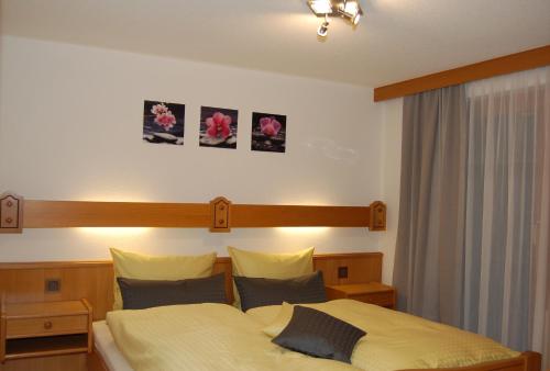 a bedroom with a large bed with two pillows at Apartment Swiss Chalet in Saas-Fee