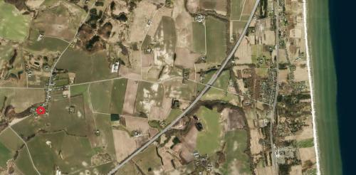 a satellite image of a city with a red dot at Købmandsgården 2 in Sæby