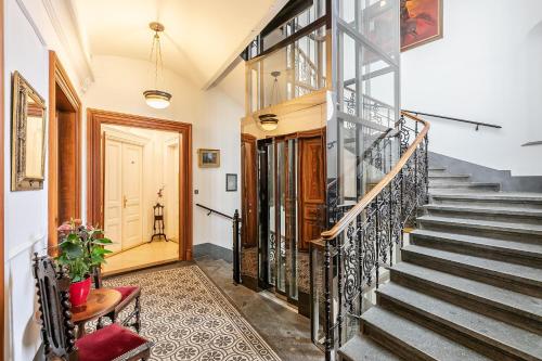 a staircase in a home with wrought iron railings at Malostranská Residence in Prague