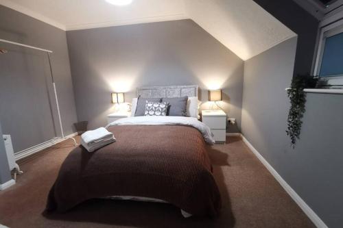 a bedroom with a large bed with two night stands at Cosy up in Palmers Leaze in Bristol