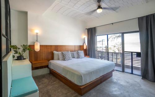 a bedroom with a large bed and a large window at Casa Pia in Sayulita
