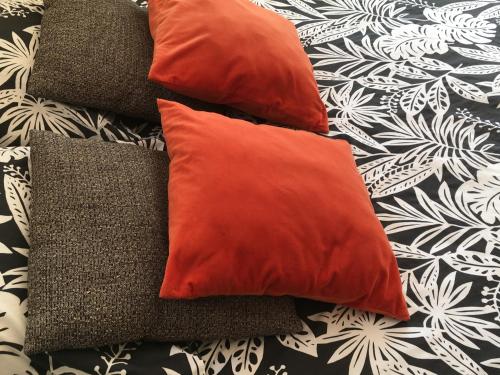 a group of pillows sitting on a bed at BY Cassis chambre privée dans maison familiale in Cassis