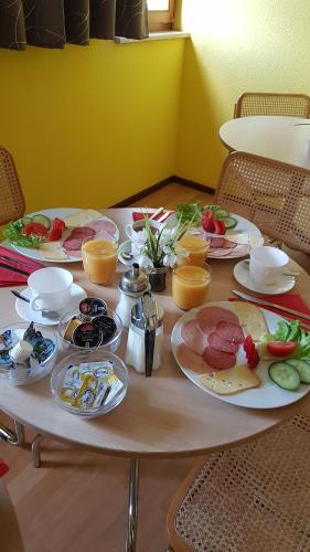 a table with plates of food on it at Scharfer Kessel in Weimar