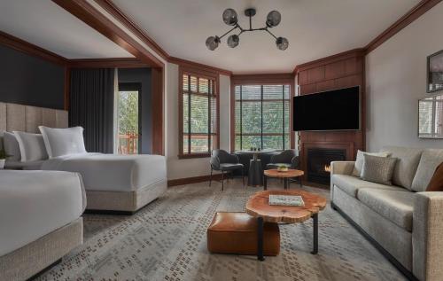 a hotel room with a bed and a living room at Four Seasons Resort Whistler in Whistler