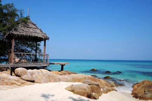 a gazebo on a beach next to the ocean at Koh Munnork Private Island in Ko Munnork