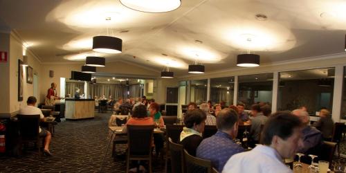a group of people sitting at tables in a restaurant at Cattlemans Country Motor Inn & Serviced Apartments in Dubbo