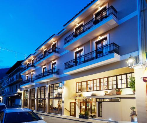a building with a car parked in front of it at Fedriades Delphi Hotel in Delfoi