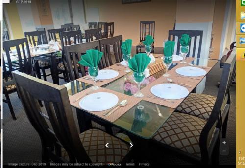 a long table with plates and glasses on it at Motel 35 in Alīābād